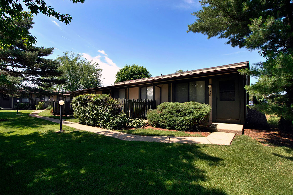 exterior rendering of a brand new three-story apartment building and the parking lot